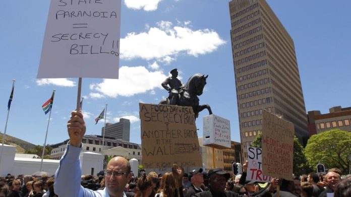 Demonstrators protest against the passing of the Protection of Information Bill outside parliament in Cape Town